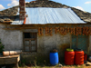 Kamnik, Kolonj, Kor county, Albania: rural house with onion braids and half stone half metal roof - photo by J.Kaman