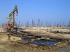 Baku district - Absheron peninsula, Azerbaijan: polluted soil and forest of oil derricks - photo by G.Monssen