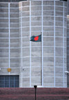 Dakha / Dacca, Bangladesh: Bangladeshi flag, a blood stain over Muslim green against the brutalist architecture of the National Assembly of Bangladesh - Jatiyo Sangshad Bhaban - photo by M.Torres