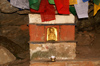 Bhutan - Paro dzongkhag - Golden figure and prayer flags, outside Taktshang Goemba - photo by A.Ferrari