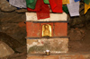 Bhutan - Paro dzongkhag - Golden figure and prayer flags, outside Taktshang Goemba - photo by A.Ferrari