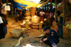 Bhutan - Thimphu - the market - policeman buying patatoes - photo by A.Ferrari