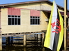Bandar Seri Begawan, Brunei Darussalam: flag of Brunei and wooden building on stilts at Kampong Pg Tajuddin Hitam water village - photo by M.Torres
