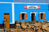 Palmeira, Sal island / Ilha do Sal - Cape Verde / Cabo Verde: boulders and the blue faade of 'Monte Reis' grocery shop - mercearia - photo by E.Petitalot