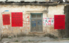 China - Hainan Island: wall with red posters (photo by G.Friedman)