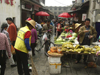 Dali, Yunnan Province, China: market scene - street sweeper at the fruit section - photo by M.Samper