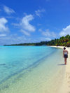 Cook Islands - Aitutaki island: girl walking along the beach - photo by B.Goode