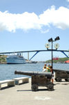 Curacao - Willemstad: Cruise ship moored in St. Annabaai channel, Queen Julianabridge in background, old cannon on Handelskade (Punda) in foreground - photo by S.Green