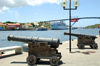 Curacao - Willemstad: Cruise ship moored in St. Annabaai channel, Queen Julianabridge in background, two old cannons on Handelskade (Punda) in foreground - photo by S.Green