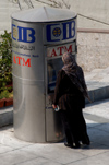 Egypt - Alexandria: muslim women using a cash machine / ATM (photo by John Wreford)