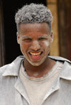 Eritrea - Mendefera, Southern region: smiling miller, covered in flour - photo by E.Petitalot