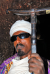 Lalibela, Amhara region, Ethiopia: Bet Mikael church - Coptic priest with mequamia praying stick - photo by M.Torres