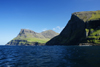 Vgar island, Faroes: coastal cliffs and rnafjall mountain - below it the village of Gsadalur - photo by A.Ferrari