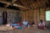 Nacula Island, Yasawa group, Ba Province, Fiji: interior of chief's house in Mala Kati Village  people on floor - bure interior - photo by C.Lovell