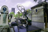 Paris, France: tombs at the Montparnasse Cemetery with Montparnasse tower in the background - 14e arrondissement - photo by K.Gapys