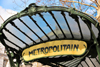 Paris, France: art nouveau entrace to metro station Abbesses, Line 12, cast iron structure with a fan-shaped glass awning, known as dicule, designed by Hector Guimard - 'Metropolitain' sign, iconic symbol of Paris - Bouche de mtro Guimard - Place des Abbesses, Montmartre district, 18e arrondissement - photo by M.Torres