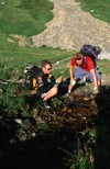 Chamonix, Haute-Savoi, Rhne-Alpes, France: mountainbikers filling their water bottles from a stream - Tour du Mont Blanc trail - photo by S.Egeberg