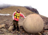 51 Franz Josef Land: Passenger next to spherical boulder, Champ Island (photo by B.Cain)
