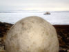 79 Franz Josef Land: Spherical boulder with ship in distance, Champ Island - photo by B.Cain