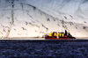 94 Franz Josef Land: Zodiac with passengers, iceberg, sea birds - photo by B.Cain