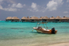 Papetoai, Moorea, French Polynesia: lagoon view - boat and overwater bungalows of the InterContinental Hotel - tropical resort - photo by D.Smith