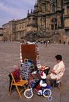 Galicia / Galiza - Santiago de Compostela - A Corua province: a woman sells souvenirs and gadgets in Praza do Obradorio - photo by S.Dona'