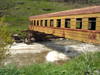 Georgia - Mtskheta-Mtianeti region: railway car used as a bridge - photo by L.McKay