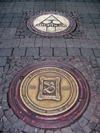 Bad Kreuznach - Rhineland-Palatinate / Rheinland-Pfalz, Germany / Deutschland: decorative manholes on a granite pavement - photo by Efi Keren