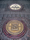 Bad Kreuznach - Rhineland-Palatinate / Rheinland-Pfalz, Germany / Deutschland: decorative manholes on a granite pavement - photo by Efi Keren