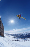 Greenland, Apussuit: skier taking air off high ice cliff - sun - photo by S.Egeberg