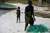 Rubane Island, Bijags Archipelago - UNESCO biosphere reserve, Bubaque sector, Bolama region, Guinea Bissau / Guin Bissau: beach, boy and man, canoe, nets / praia, homem e criana, canoas, redes de pesca - photo by R.V.Lopes