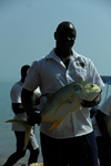 Rubane Island, Bijags Archipelago - UNESCO biosphere reserve, Bubaque sector, Bolama region, Guinea Bissau / Guin Bissau: Hotel Punta Anchaca, man showing the fish he just caught - crevalle jack, Caranx hippos / Hotel Punta Anchaca, homem na praia a mostrar o peixe apanhado - Xaru-macoa - photo by R.V.Lopes