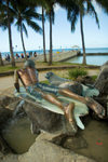 O'ahu island - Oahu island - Waikiki beach: surfer and seal - Duke Paoa Kahanamoku statue - palm trees and ocean in background - photo by D.Smith