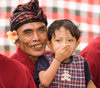 Padangbai, Bali, Indonesia: toddler and musician with frangipani and turban - photo by D.Smith