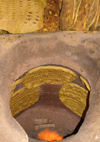 Yazd, Iran: baking bread in a tandoor, a cylindrical clay oven - photo by N.Mahmudova