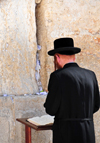 Jerusalem, Israel: Orthodox man reading the Torah from a small table at the Wailing wall - Hasidic Jew - written prayers in the crevices of the Wall / Western Wall / HaKotel - muro das lamentaes - Mur des Lamentations - Klagemauer - photo by M.Torres