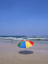 Israel - Kibbutz Sdot Yam: rainbow umbrella - photo by Efi Keren