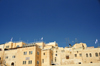Jerusalem, Israel: stone buildings - view from the Western Wall plaza, Yeshivat Netiv Aryeh - Zionist Orthodox yeshiva - flags and antennas - Jewish quarter - Blue sky background as copy space for your text - photo by M.Torres