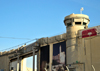 Jerusalem, Israel: Rachel's Tomb Crossing Checkpoint, main vehicle gate leading to  Bethlehem and watch tower - part of the Israeli West Bank barrier, security fence made of concrete slabs - poster with David's tower -  Israeli Defense Forces (IDF) - photo by M.Torres