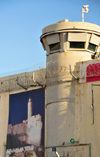 Jerusalem, Israel: Israeli Defense Forces (IDF) sentry tower with surveillance cameras and barbed wire at Rachel's Tomb Crossing Checkpoint - watch tower near Bethlehem, part of the Israeli West Bank barrier, security fence made of concrete slabs - poster with David's tower - photo by M.Torres