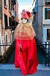 Carnival participant with Carnival costume on bridge overlooking canal, Venice - photo by A.Beaton