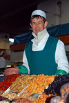 Kazakhstan, Almaty:green market, or Zelyoni Bazaar - Uzbek merchant with gold teeth selling dried fruits - photo by M.Torres