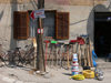 Serbia - Kosovo - Pec / Peja: broom and hardware store - tools and 'medic' sign - photo by J.Kaman