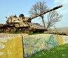 Shera Swars, Kurdistan, Iraq: wrecked Iraqi army T-55 tanks, destroyed in combat by the Kurdish Peshmerga forces in a battle in 1991 - mural celebrating the Kurdish victory - photo by M.Torres