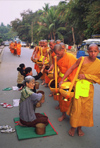 Laos: Buddhist monks - food distribution - photo by E.Petitalot