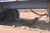 Laos: a driver takes time off in a hammock in the shade under his truck - photo by E.Petitalot