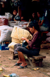 Laos - Vientiane - Woman looking for her money - morning market - photo by K.Strobel
