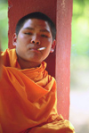 Laos: a young monk smokes a cigarette - photo by E.Petitalot