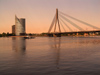 Latvia / Latvija - Riga: dusk on the Daugava - suspension bridge and skyscrapper (photo by J.Kaman)