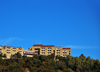 Maseru, Lesotho: the hill-top Lesotho Sun hotel and casino, sandstone building surrounded by forest - Hilton Road - photo by M.Torres